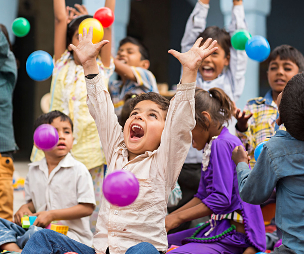 A smiling child supported by C.S.R.D nutrition programs